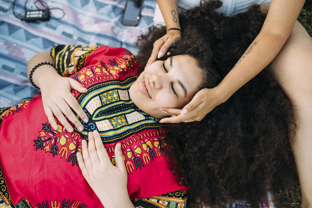 Young woman enjoying face massage by friend Summer Recharge: Essential Self-Care Tips for Teachers